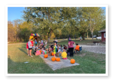 Kids having fun carving pumpkins at Wooded Acres RV Park